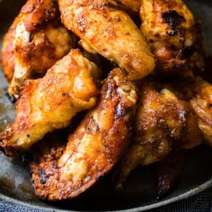 A photo of a plate full of dry rubbed smoked chicken wings.
