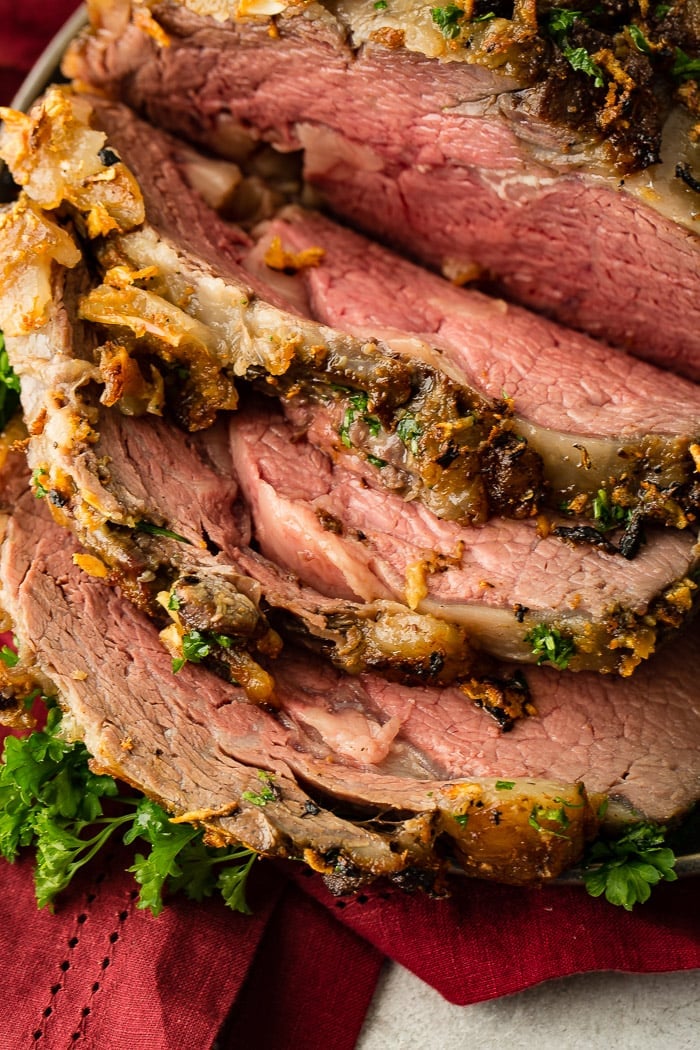 Close-up of juicy prime rib slices showing tender marbling and crispy outer crust.