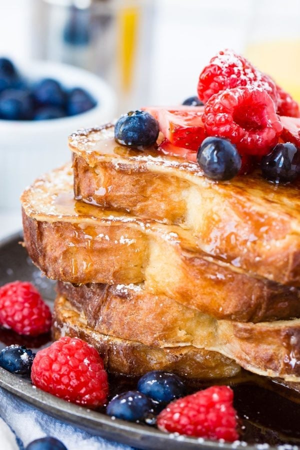 How to Make French Toast a stack of 4 perfectly made french toast slices dripping with syrup and fresh berries. How to Make French Toast