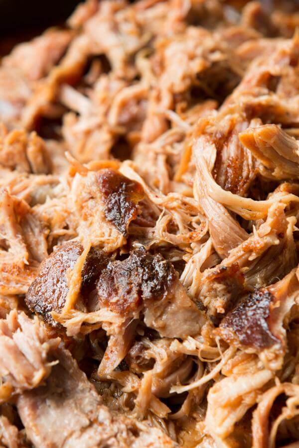 Want to make the best pulled pork from your own kitchen? This recipe for the world's best Carolina pulled pork all starts with a brine. close up photo of homemade pulled pork